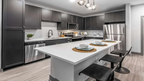 01-westerly-kitchen-island Modern kitchen with stainless steel appliances at The Westerly